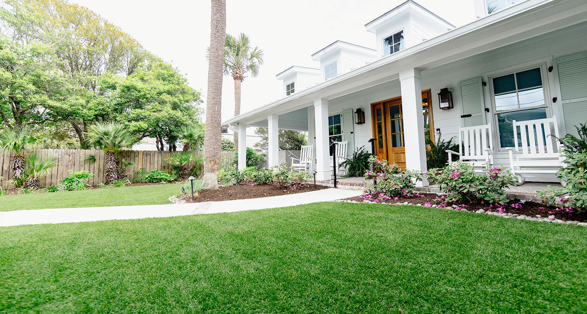 Luxury backyard with synthetic turf lawn, pool, patio, and modern home